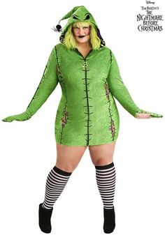 a woman in a green costume is standing with her hands on her hips and legs crossed