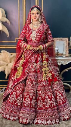 a woman in a red and gold bridal gown