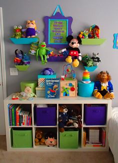 there is a toy shelf with many toys on it in the room, including mickey mouse and other stuffed animals