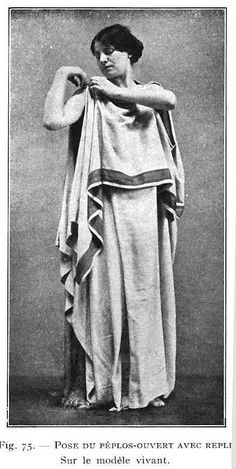 an old black and white photo of a woman dressed in roman garb with her arms crossed