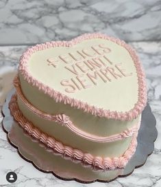 a heart - shaped cake with pink icing on a marble counter top that says i love you so much