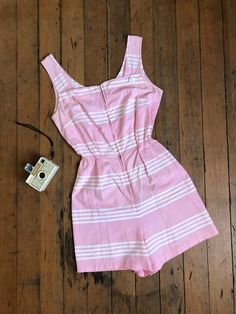 "*SHIPPING ANNOUNCEMENT* Away for the Holidays so enjoy a discount! Will ship sometime before the New Year but unsure exactly which day. Super cute pink cotton romper from the 1950s. This one has a metal zipper up the front and elastic at the waist for more movement.  Label: none Measurements: { xsmall - small } Bust: 34\"/35\"  Waist: 20\"-28\"  Hips: 37\" Length: 31\" Rise: 14.5\" Condition: excellent vintage condition with minor signs of wear - sold as found. washed and ready to wear  ☆Shop☆ http://www.trunkofdresses.com/" 1950s Shirtwaist Dress, Vintage Romper, Pink Romper, Womens Jumpsuits, Pink Rompers, Vintage Pin Up, Cotton Romper, Star Dress, Fashion Design Clothes