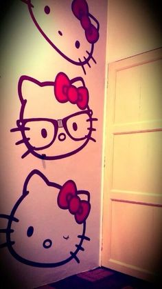 two hello kitty wall decals on the side of a door