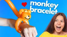 a woman pointing at an orange monkey balloon on her arm with the words monkey balloon bracelet