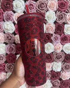 the starbucks cup is decorated with red and black sequins