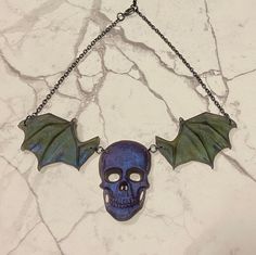 Resin winged skull, resin necklace with chain attachment and clasp with extension chain. Length: 15.5 inches - 18 inches (40 - 46cm) Handmade Gothic Skull Necklace, Gothic Purple Necklace For Halloween, Goth Rock, Winged Skull, Necklace Resin, Wing Shoes, Necklace Purple, Dragon Wings, Skull Necklace