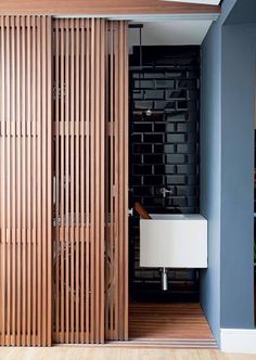 a bathroom with wooden slatted walls and flooring