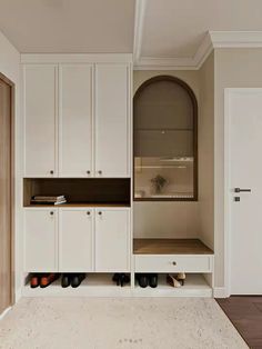 a room with some white cupboards and shoes