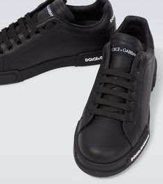 Find DOLCE & GABBANA Logo Leather Sneakers on Editorialist. Lining: leather. Sole: leather insole, rubber sole. Toe shape: round toe. Upper: leather. Closure: lace-up. Designer color name: Black/Black. Comes with a box. Made in Italy. Comes with dust bag. Black Sneakers With Vulcanized Sole In Calf Leather, Black Calf Leather Sneakers With Vulcanized Sole, Calf Leather Sneakers With Vulcanized Sole And Round Toe, Designer Sneakers With Stitched Sole And Round Toe, Black Leather Sneakers With Studded Outsoles, Sneakers With Leather Sole And Round Toe, Leather Sole Sneakers With Round Toe And Medium Fit, Designer Black Leather Sneakers, Designer Leather Sneakers With Round Toe