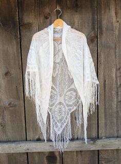 Lovely metallic silver lace piano shawl, 1980s vintage.  Perfect long drape & length, with luxurious fringe and woven Art Deco floral detailing.   An elegant accessory for a night out, or a Bohemian touch for your skinny jeans and cowboy boots. Very romantic, old-world, and timeless. Made in Japan 55% rayon, 30% nylon, 15% lurex roughly 73 inches at it's widest (not counting fringe) roughly 51 inches at it's longest (not counting fringe) fringe roughly 7 inches long Some general fabric wear, inc Bohemian Fringe Shawl For Festivals, Fringed Shawl For Summer Festivals, Summer Shawl With Fringe, Summer Fringe Shawl, Bohemian Crochet Lace Shawl, White Bohemian Scarf For Fall, Summer Shawl With Tassels, Bohemian Crochet Lace Shawl For Spring, Bohemian Crochet Lace Shawl Scarf