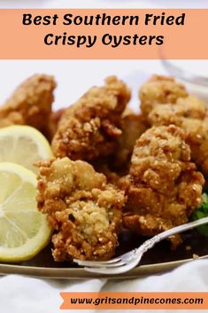 the best southern fried crispy oysters on a plate with lemon wedges and greens