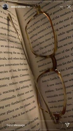 an open book with glasses on top of it and the caption's page below