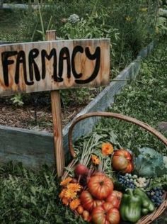 a basket filled with lots of vegetables next to a wooden sign that says farmacy