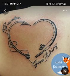 the back of a woman's shoulder with an arrow and heart tattoo