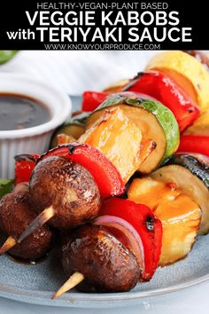 the skewers are loaded with vegetables and sauce on the plate, ready to be eaten