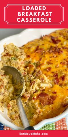 loaded breakfast casserole in a white dish with a serving spoon