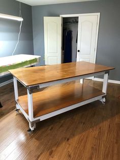 a kitchen island with two shelves on each side and an open closet in the background