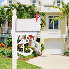 a white mailbox sitting in front of a house