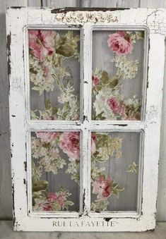 an old window with flowers painted on it