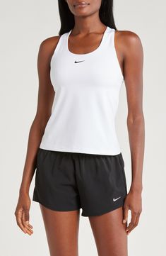 A built-in shelf-bra keeps you supported in this racerback tank top cut with signature Dri-FIT technology for cool, dry comfort as you work up a sweat. 20 1/2" length (size medium) Scoop neck Racerback Built-in shelf-bra Dri-FIT moisture-wicking technology 82% polyester, 18% spandex Machine wash, line dry Imported Functional Racerback Tops For Sports Events, Nike Tops For Light Sports, Racerback Top With Medium Support For Sports Events, White Nike Racerback Top, White Racerback Top With Mesh Back, Nike Racerback Tops For Sports Events, Nike Sporty Tops With Light Support, Sporty Tank Top For Training, Nike Racerback Tops For Workout