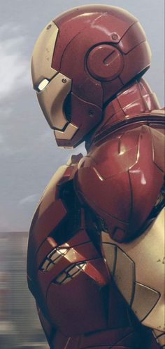 the iron man is standing in front of a cloudy sky