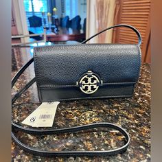 Nwt Tory Burch Black Miller Wallet Crossbody Bag Flap Top With Gold Logo Medallion Adjustable Crossbody Strap Dimensions: 7.6"W X 2"D X 4.8"H Snap Flap Closure Exterior Back Slip Pocket, Interior Zip Pocket And Six Card Slots Dust Bag Retail $328 Brand New With Tags Check Out My Other Listings Fast Shipper: Same Day/Next Day Shipping Travel Wallet With Gold-tone Hardware, Crossbody Wallet On Chain With Branded Hardware, Wallet On Chain With Branded Hardware For Everyday Use, Crossbody Wallet On Chain With Mobile Phone Bag, Black Crossbody Wallet On Chain, Black Wallet With Gold-tone Hardware Crossbody, Black Crossbody Wallet With Gold-tone Hardware, Tan Leather Wallet On Chain For Everyday Use, Tory Burch Bag