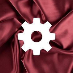 an image of a red satin background with white gears on the center and bottom part