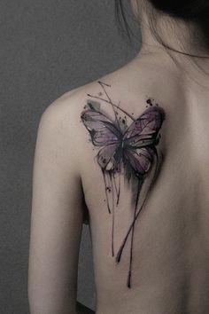 a woman with a butterfly tattoo on her back