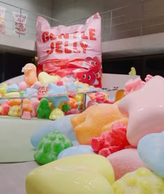 there are many gummy bears on display in the store, and one is pink