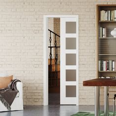 a living room filled with furniture and a book shelf next to a white brick wall