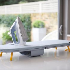 an ironing board sitting on top of a table