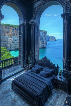 a bed sitting in the middle of a bedroom next to an ocean