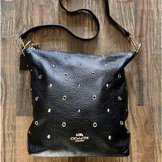 Coach Abby Duffle Black Crossbody Handbag; Black Pebbled Leather, Zipper Closure, Gold And Silver Accent Studs, Back Zipper Pocket, Interior Zipper Pocket, Detachable Adjustable Strap. Slight Wear On Ring Hardware (See Photo), No Scuff Or Rips O Leather Or Interior. Gently Used Handle Drop: 7.75” Strap Drop: 20.5” L: 9.75” H:12” W: 4” Coach Crossbody Hobo Bag With Zipper Closure, Coach Shoulder Bag With Snap Closure, Chic Coach Shoulder Bag With Snap Closure, Coach Black Shoulder Bag With Snap Closure, Black Coach Shoulder Bag With Snap Closure, Bags Coach, Black Pebbles, Handbag Black, Black Crossbody