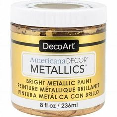 a jar of metallic paint sitting on top of a white table