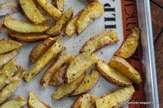 baked potato wedges sitting on top of a baking sheet