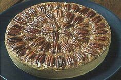 a pecan pie sitting on top of a blue plate