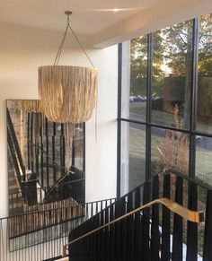 a chandelier hanging from the side of a staircase