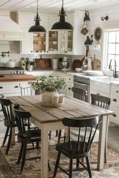 a kitchen table with four chairs around it