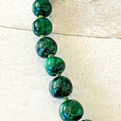 In very good condition, the beads are round, graduated, and cut by hand, not machine. The slight variation in shape gives it an organic feel. The beads are cut by hand and not machine cut. The natural Malachite beads are a deep shade of green with natural variations and few inclusions, if any. The handmade brass hook clasp has a lovely warm patina. The beads are knotted on a thick cotton thread, one knot between each bead. The size of the round beads varies from 5/8 inch (16mm) in diameter at th Silk Cord Necklace, Round Bead Necklace, Art Necklaces, Brass Hook, Jewelry Tags, Handmade Brass, Silk Cord, Hook Clasp, Cord Necklace