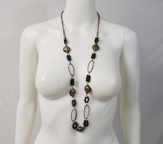 "This necklace is a very nice combination of black aurora borealis crystal beads, dichroic art glass beads, copper chain, and copper wire. The large links formed with the copper wire are especially interesting. All in all, this necklace has an organic, neutral design that you will be able to pair up with many outfits. The necklace is long and adjustable in length. Depending on where you hook the lobster claw clasp, it can be anywhere from 29-1/2\" to 37-1/2\". This necklace has a metal hang tag Black Bohemian Glass Jewelry, Black Glass Bohemian Jewelry, Black Copper Bohemian Necklaces, Black Bohemian Copper Necklace, Bohemian Black Glass Jewelry, Bohemian Black Copper Necklace, Black Glass Chain Jewelry, Elegant Black Copper Jewelry, Adjustable Black Copper Necklace