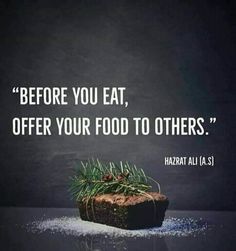 a piece of bread sitting on top of a table next to a blackboard with the words before you eat, offer your food to others