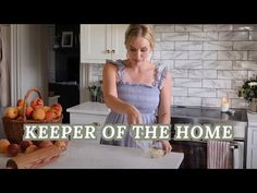 a woman standing in a kitchen preparing food on top of a cutting board with the words keeper of the home