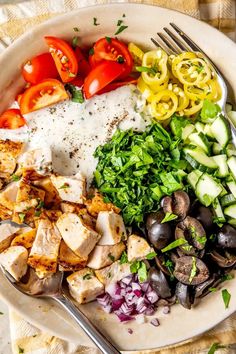 Boneless, skinless chicken breasts are seared and cooked in the oven before being tossed in a veggie-rich salad with bright tomatoes, crunchy cucumbers, salty kalamata olives, spicy pepperoncini, and a simple yogurt-based, Greek-inspired sauce! #chickensalad #highprotein