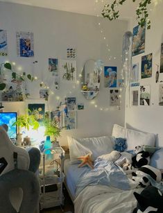 a bedroom with pictures on the wall and stuffed animals in it's bed area