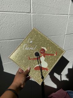 someone is holding up a graduation cap