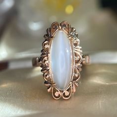 Beautifully Detailed Scalloped Detailing Enhances A Lovely Large Oval Moonstone Cabochon In This Retro 1940s Era Cocktail Ring. Ready To Be Worn And Adored By A New Owner This Well Crafted Ring Weighs A Hefty 6.16g In 14k Rose Gold, Indistinctly Stamped, Tested For Content. Currently A Size 6, Sizable. This Vintage Ring Was Lightly Worn And Remains Excellent Condition For Its Age. The Moonstone Is Approximately 7.25 Carats By Measurement And Is White With A Strong White Cat's Eye Adularescence. Dinner Ring, Retro Cocktail, Ring Birthstone, Rose Gold Metal, Vintage Ring, Birthstone Ring, Cocktail Ring, Womens Jewelry Rings, Cocktail Rings