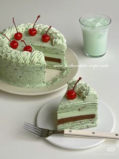 two pieces of green cake with cherries on top and one slice missing from the cake