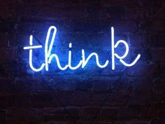 the word think written in neon blue light