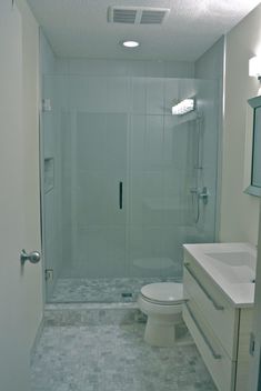 a bathroom with a shower, toilet and sink