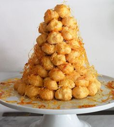 a white plate topped with tater tots on top of a marble countertop